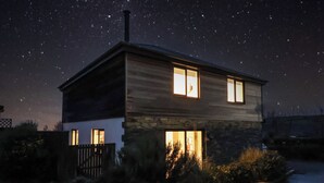 A two-story house with a stone facade and a wooden upper level. - 3 Praa Cove (Penzance)