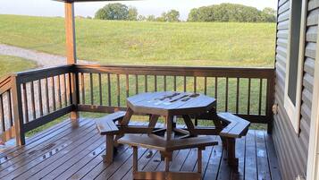 Enjoy a meal on the sheltered deck with a view of the surrounding grassy field.