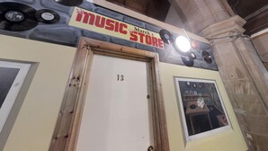 A building with a sign reading "MUSIC STORE" above a door labeled "13". - Belford Hostel (Edinburgh)