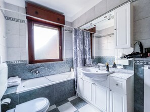 Bathtub, hair dryer, towels