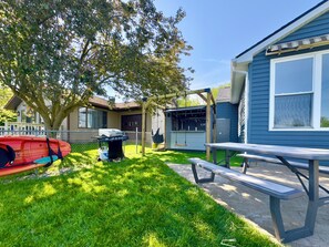 A backyard with a picnic table, a barbecue grill, and a swing set. - Lake + Waterfront + Dock + HotTub + Kayaks + Walking distance to Woody's (Russells Point)