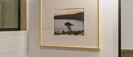 A framed landscape painting on a wall.