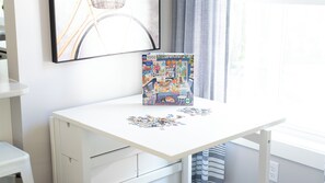 A white desk with a puzzle box and scattered puzzle pieces. - "Upside" New Cottage w Custom Built Bunk Room - Inside LKSD Gates (Lakeside Marblehead)