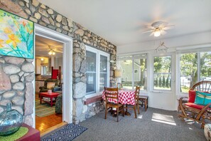 Cozy interior space with a dining area, comfortable sofa, and a welcoming entrance.