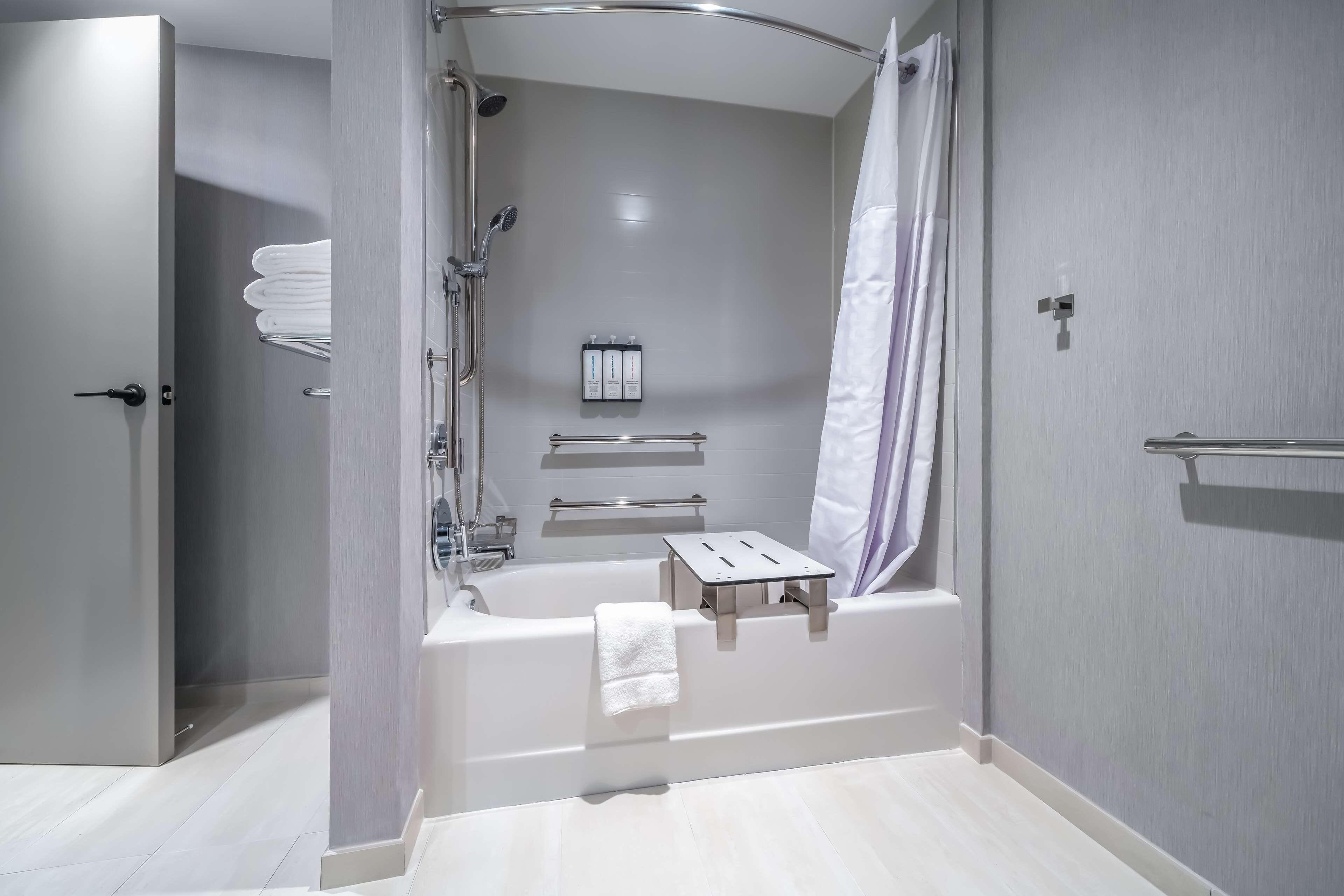 A modern bathroom with a walk-in shower, a bathtub, and a toilet.