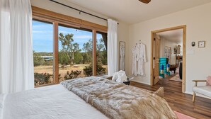 A bedroom with a large bed, a ceiling fan, and a view of the outdoors. - Large Villa ~ Kings & Queens ~ Chefs Kitchen ~ Views~ Hot Tub! (Sedona)