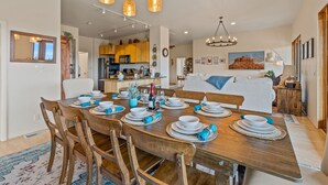 A dining area with a wooden table set for six, surrounded by wooden chairs. - Large Villa ~ Kings & Queens ~ Chefs Kitchen ~ Views~ Hot Tub! (Sedona)