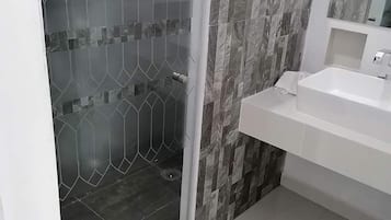 Bathtub, towels, soap, toilet paper