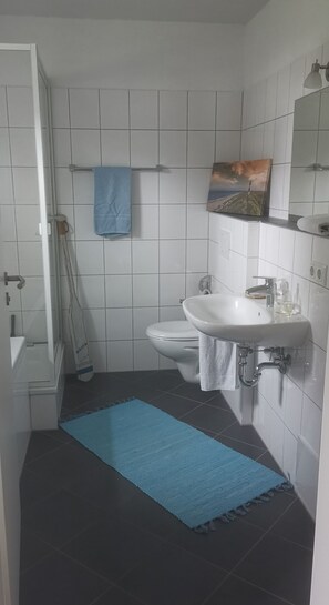 Bathtub, hair dryer, towels, soap