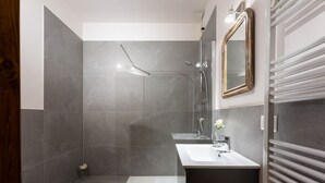 Une salle de bain moderne équipée d’une douche, d’un lavabo et d’un bidet.