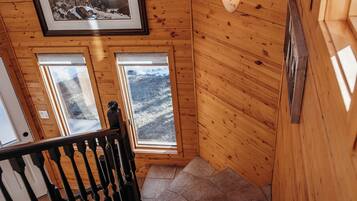 A wooden staircase with a handrail and a framed picture on the wall.