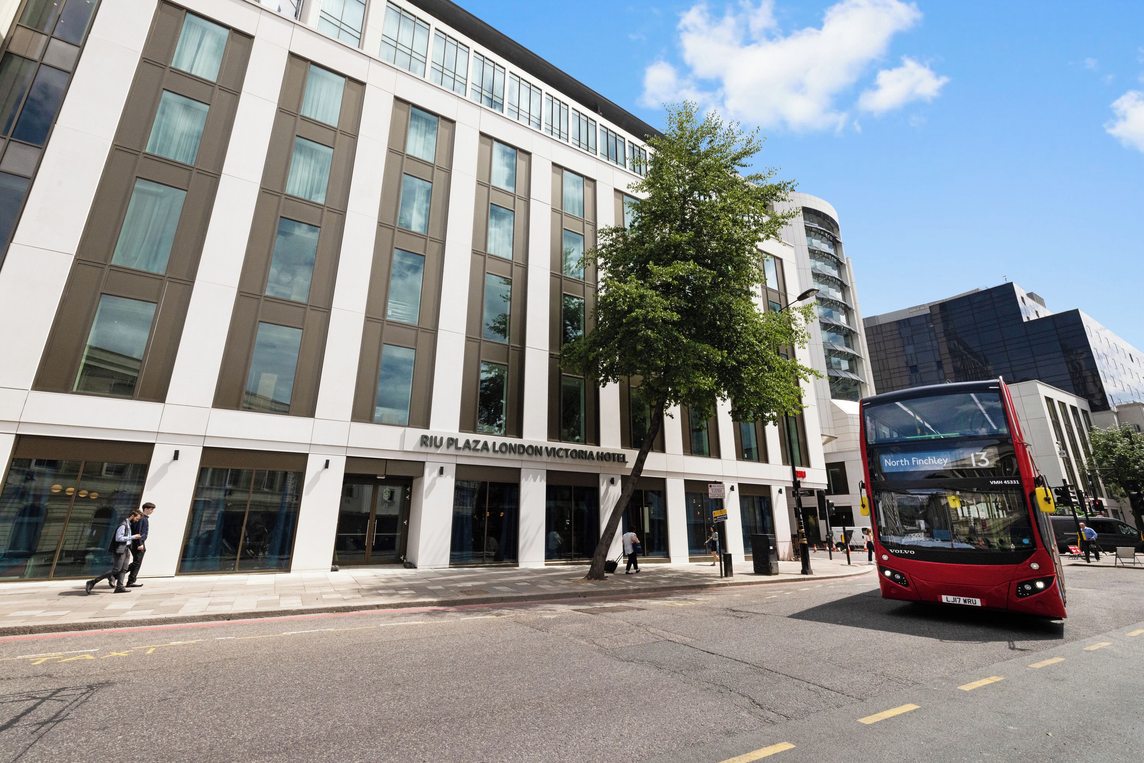 Een modern gebouw met een bord voor het Riu Plaza London Victoria Hotel.