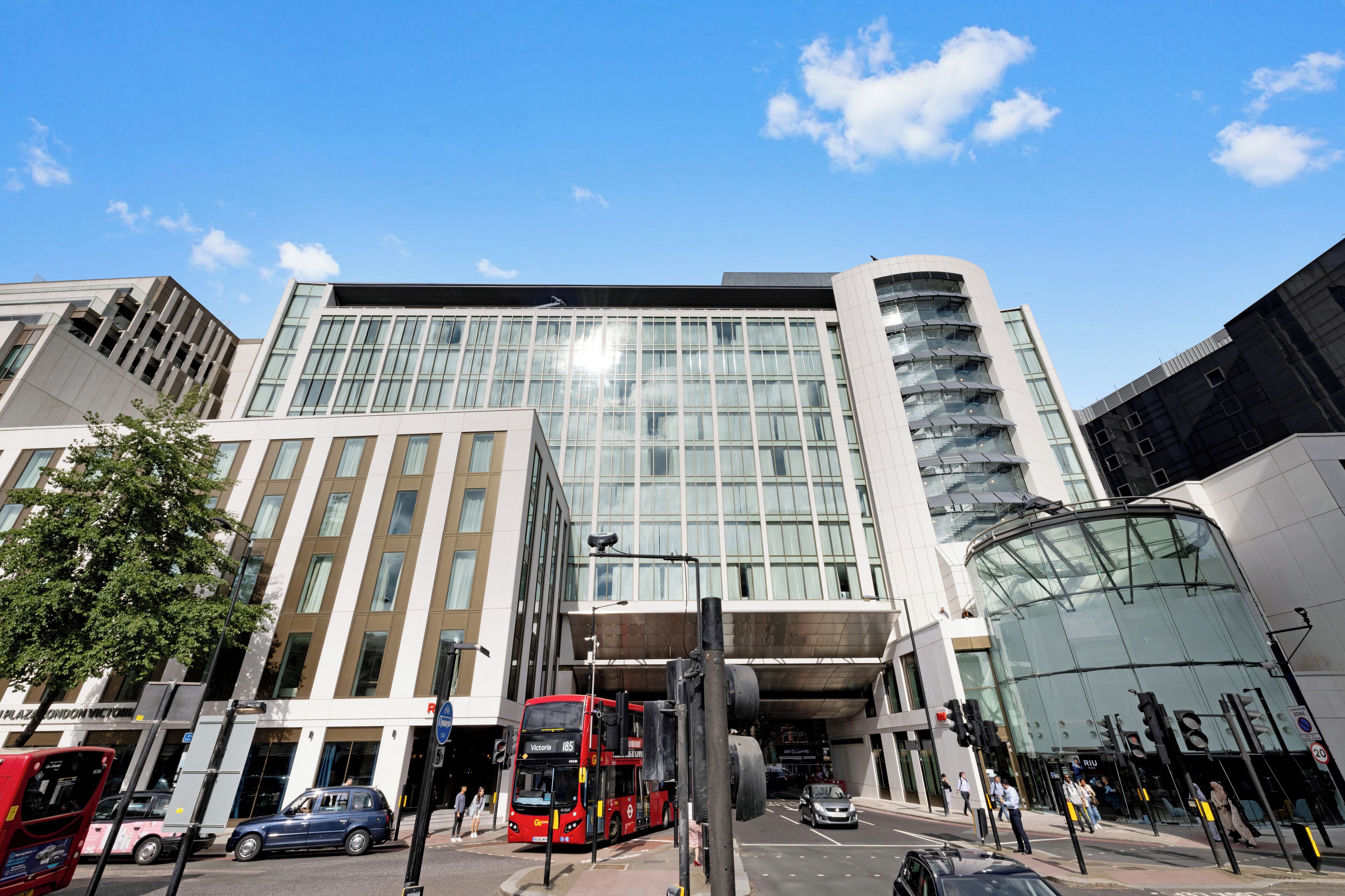 A modern building with large windows and a curved glass facade.