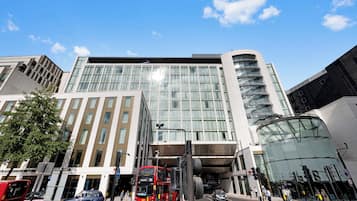 A modern building with large windows and a curved glass facade.