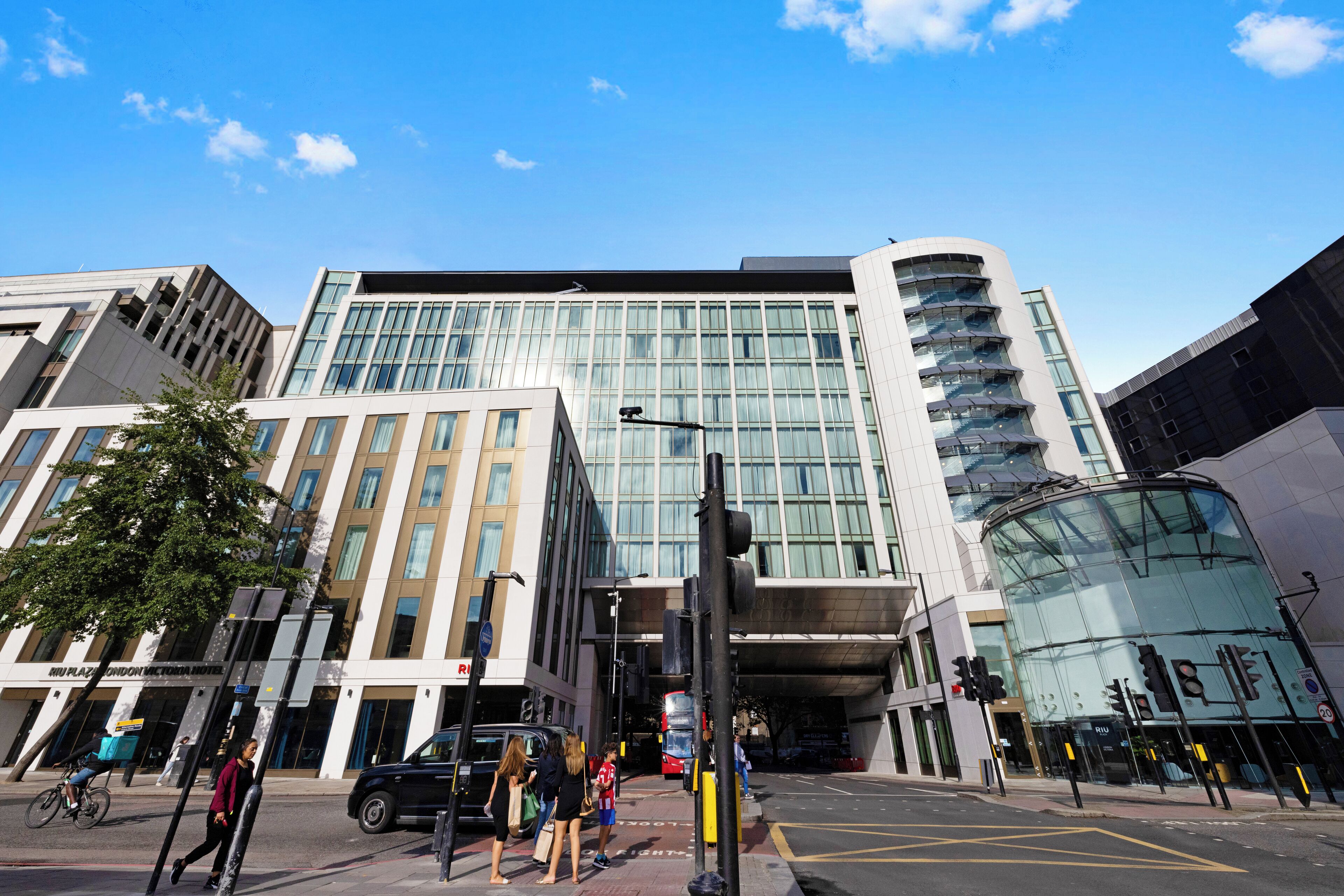 A modern building with a glass facade and a curved entrance.
