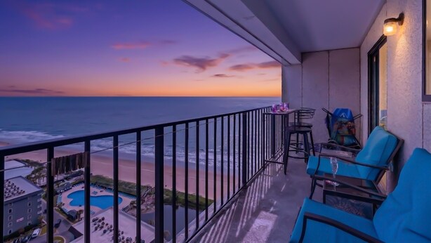 A balcony with a view of the beach and ocean at dusk. - Myrtle Beach Resort by Elliott Realty (Myrtle Beach)