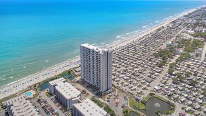 A high-rise hotel with a view of the beach and ocean. - Myrtle Beach Resort by Elliott Realty (Myrtle Beach)