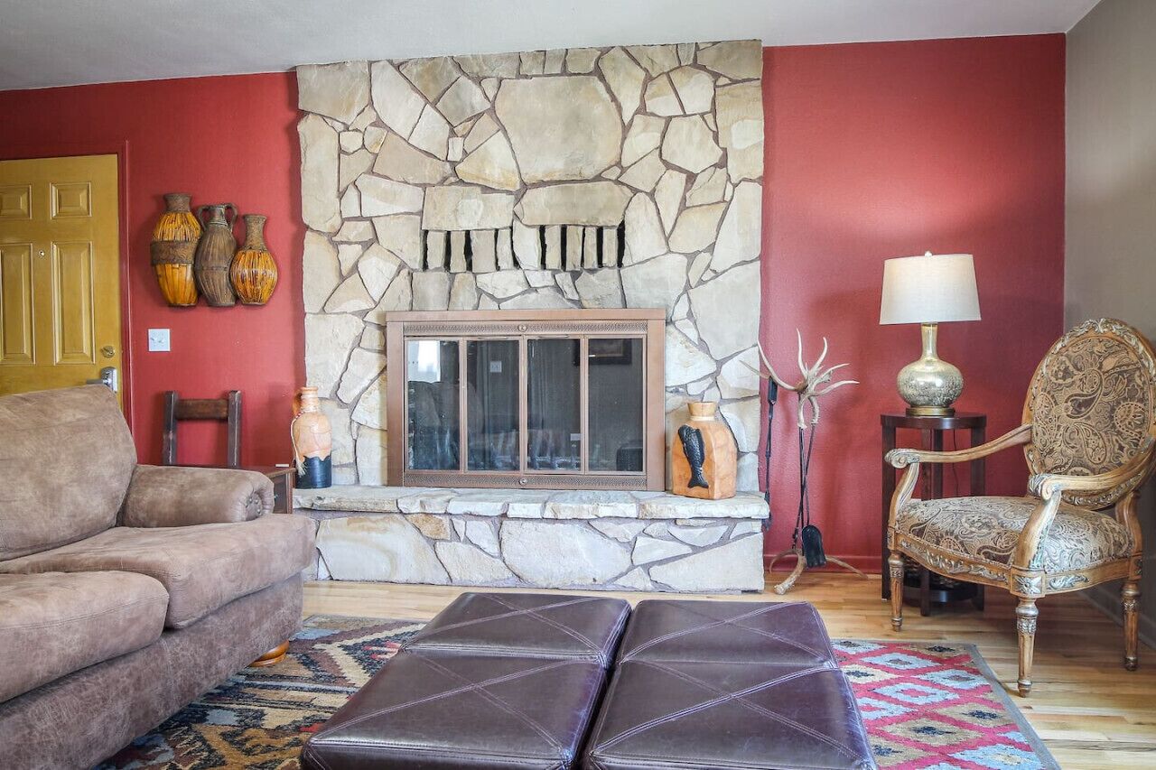 Cozy living room with large picture window to let in ample natural light.  Settle in by the fireplace and relax!