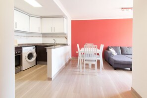 A compact living space with a kitchen, a dining area, and a seating area.