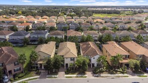Homes in a well-planned community with solar panels and mature trees.
