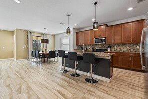 Prepare meals and enjoy casual dining at the kitchen island with bar stools.
