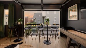 A modern interior with a balcony, a bar area with stools, and a wooden bench. - Stunning West End Home - Walkable Area (Nashville)