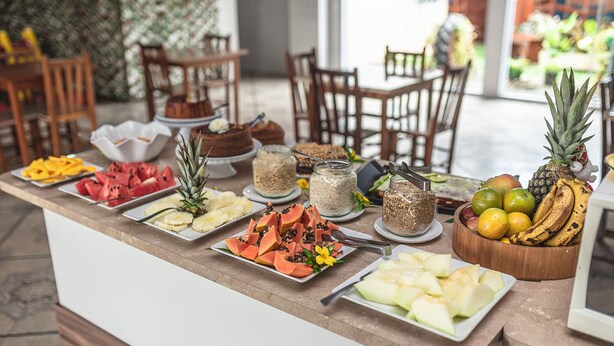 A buffet with various fruits and desserts. - Eco hotel (Navegantes)