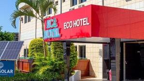 An ECO HOTEL with a red awning, solar panels, and a paved entrance area. - Eco hotel (Navegantes)