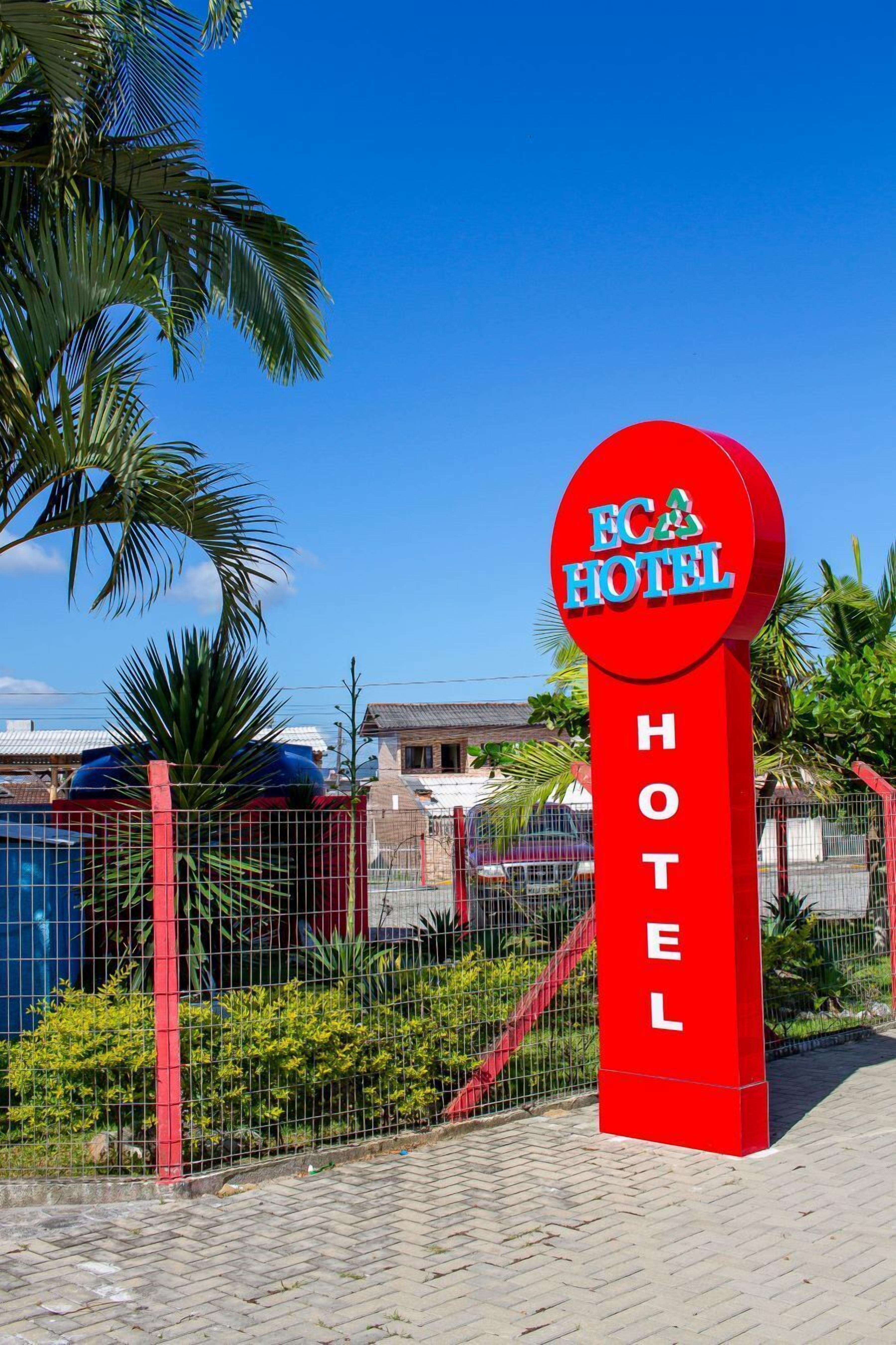 A red sign with 'ECASA HOTEL' written on it, indicating the name of the hotel.