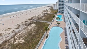 A hotel with a pool, beach, and ocean view. - Lighthouse 703 "Sea Haven" Beachfront condo with huge balcony! (Gulf Shores)