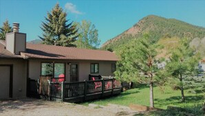 A single-story house with a porch, a chimney, and a mountain in the background. - "Almost Heaven" Palmer Lake, CO (#STR0419522) (Palmer Lake)