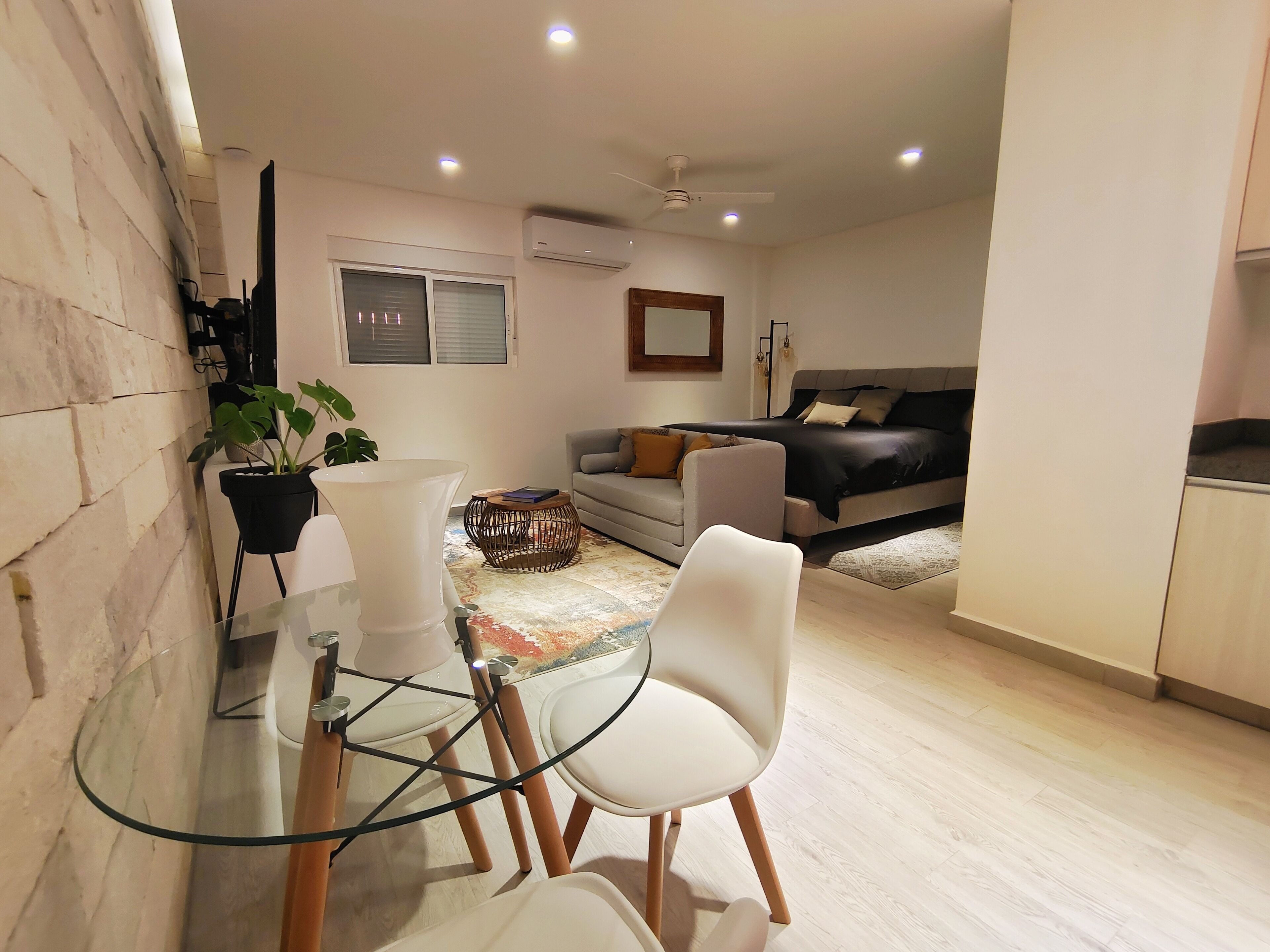 Suite estudio de lujo | Área de sala de estar | Smart TV de 65 pulgadas con canales digitales, televisión y Netflix 