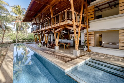 Open, dog-friendly, beachfront house with a private pool, pool spa, & WiFi