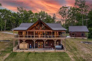 Enjoy a peaceful retreat in this charming cabin with a spacious balcony and cozy front porch.