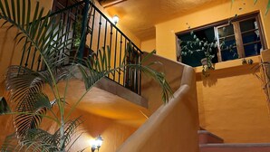 A staircase with a handrail, surrounded by potted plants. - WATER VIEWS! Luxury Boho In-Village Apt #3 (Boca de Tomatlán)