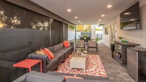 A modern outdoor living area with a sofa, chairs, and a coffee table.