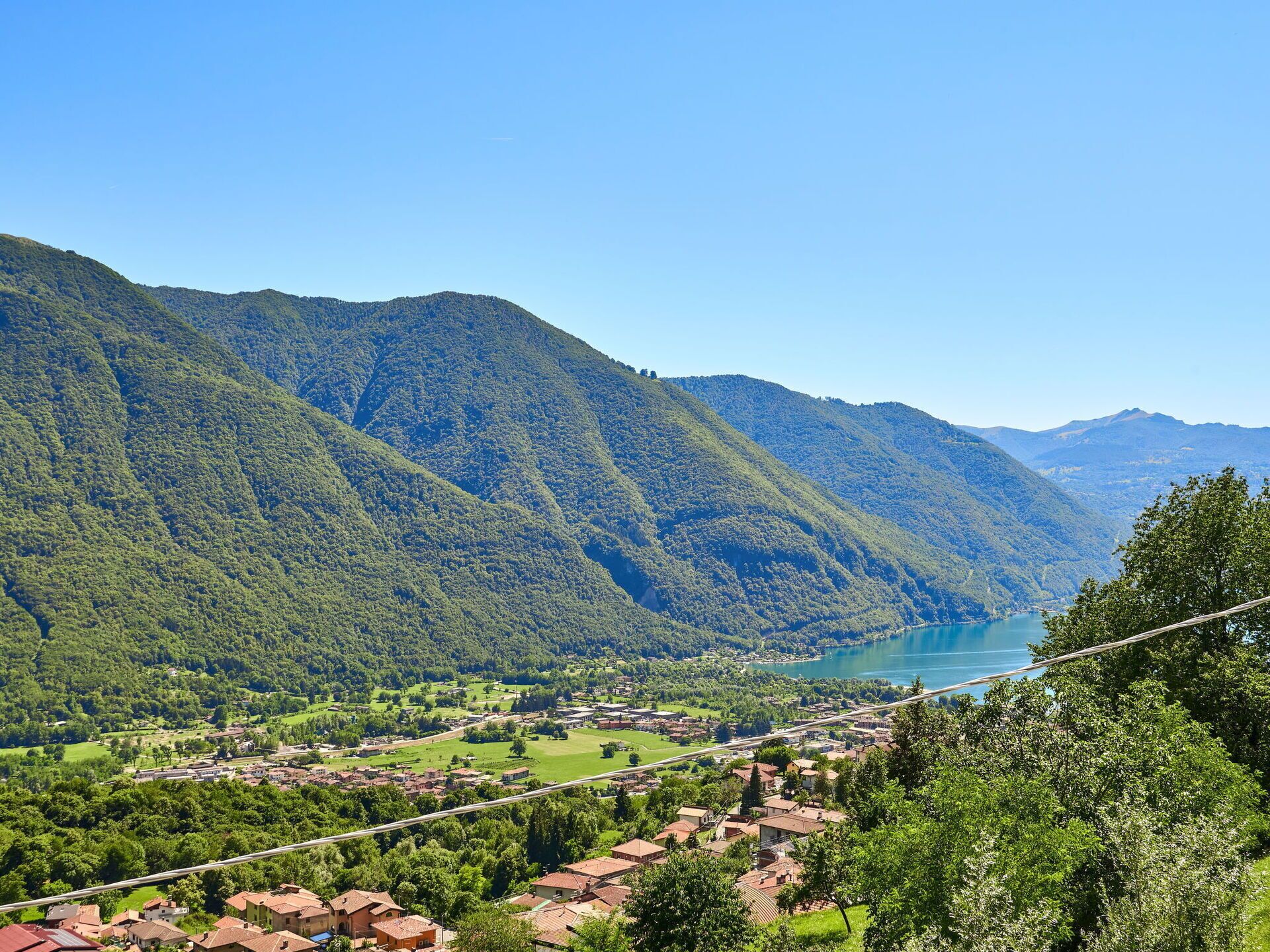A mountainous landscape with a lake and a village.