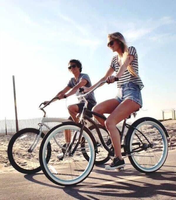 Two people riding a tandem bicycle on a paved path. - Salty Starfish: Work-Play-Relax-Beach-Bay-Pets OK (Long Beach)