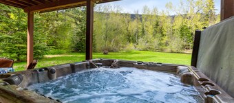 Dog-friendly riverfront home with hot tub, large yard, and fast Wifi