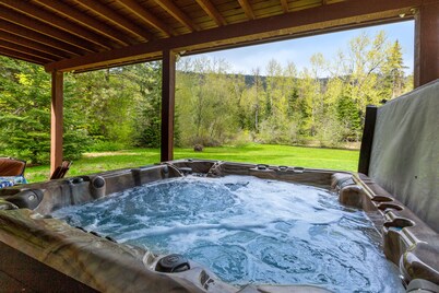 Dog-friendly riverfront home with hot tub, large yard, and fast Wifi