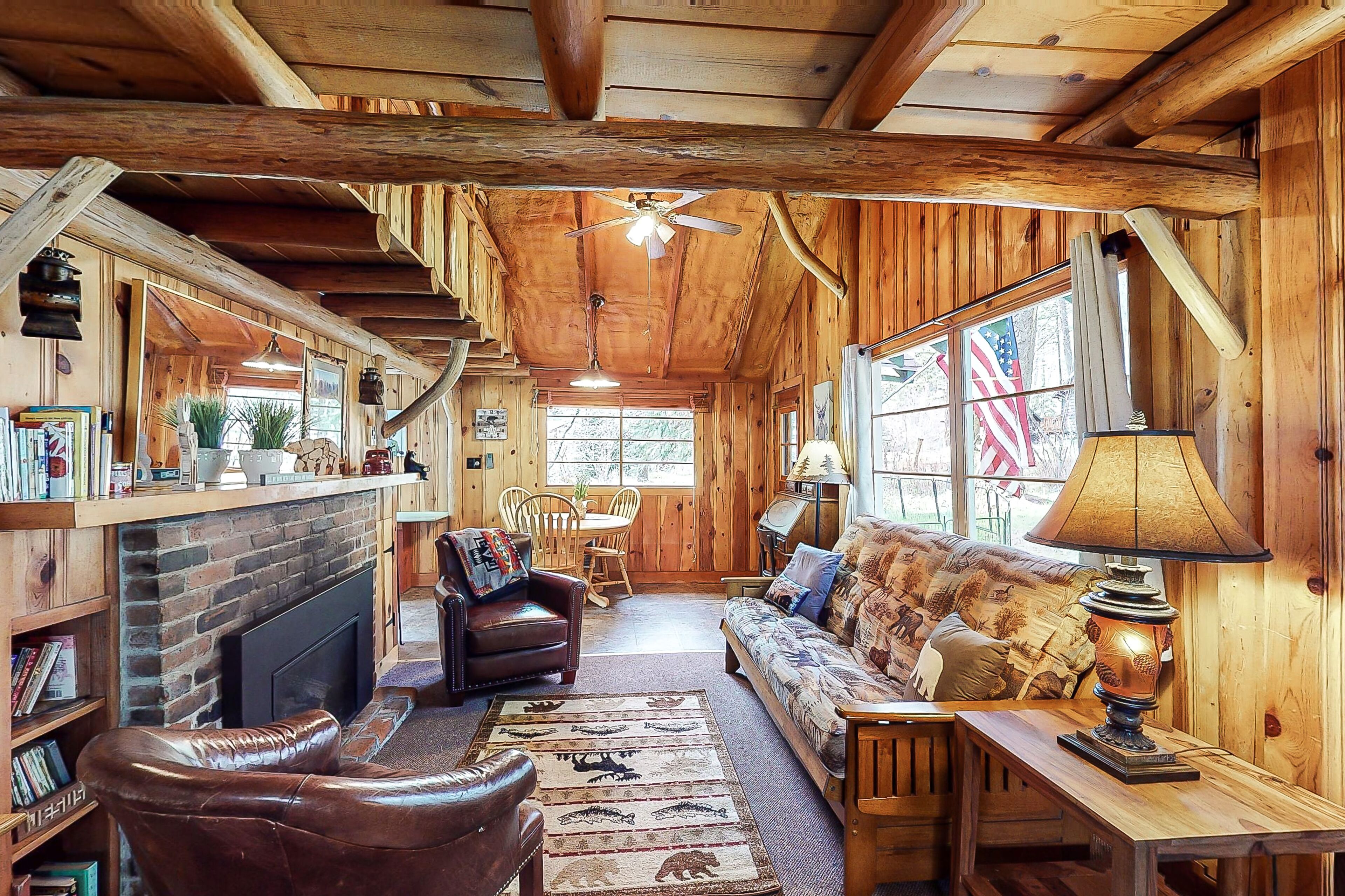 Woodsy riverfront basecamp with fireplace, large deck & firepit - dogs welcome
