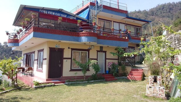 A two-story building with balconies and potted plants. - Beautiful Lakeview rooms just 10 min by taxi from mainroad (Pokhara)