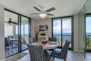 Enjoy meals and scenic views from this spacious balcony with a round dining table and comfortable seating.