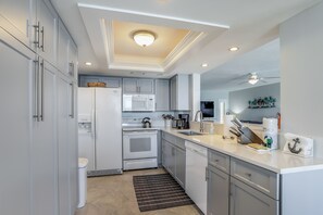Enjoy cooking in this well-equipped kitchen with oven, microwave, and dishwasher.
