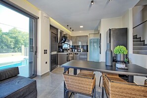 Enjoy meals in the adjacent dining area with a long table and comfortable seating.