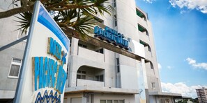 A hotel sign with the name "Pacific View" and a large, colorful sign with the name "Pacific" partially visible. - HOTEL PACIFIC VIEW (Okinawa)