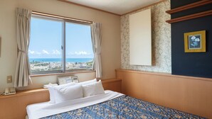 A hotel room with a bed, a window with curtains, a thermostat, a phone, and framed pictures on the wall. - HOTEL PACIFIC VIEW (Okinawa)
