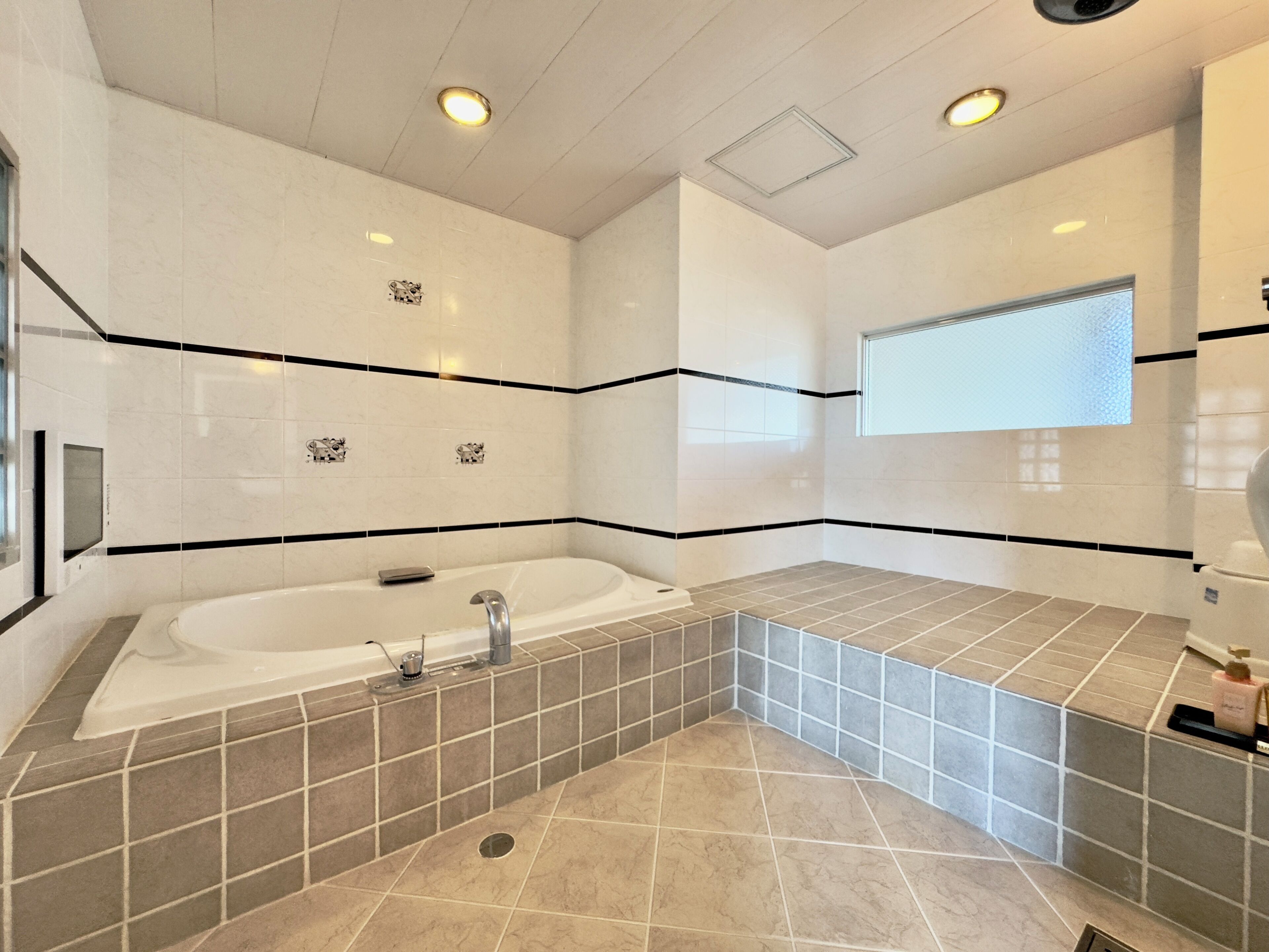 A modern bathroom with a freestanding bathtub, a shower area, and a vanity with a mirror.