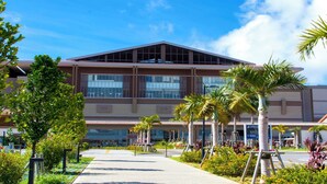 A modern building with a flat roof, large windows, and a covered entrance area. - HOTEL PACIFIC VIEW (Okinawa)
