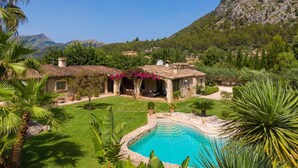 A villa with a swimming pool, surrounded by lush greenery and mountains. - Villa Can Brullet by SunVillas Mallorca (Pollença)